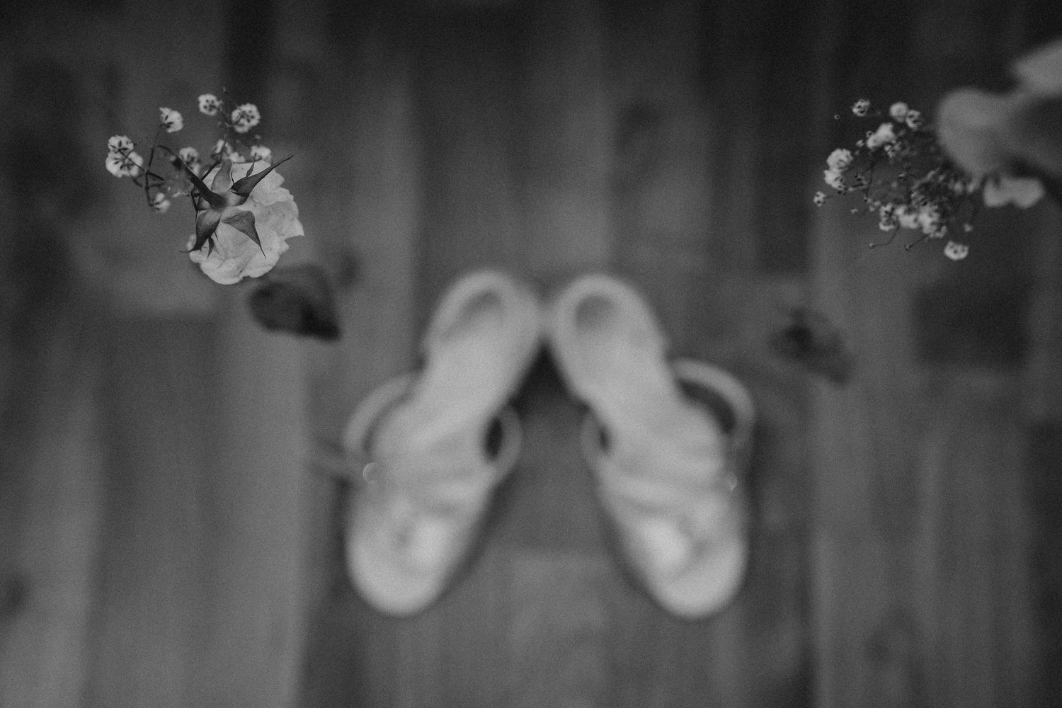 Black and white artistic detail shot of wedding decorations with soft bokeh effect.