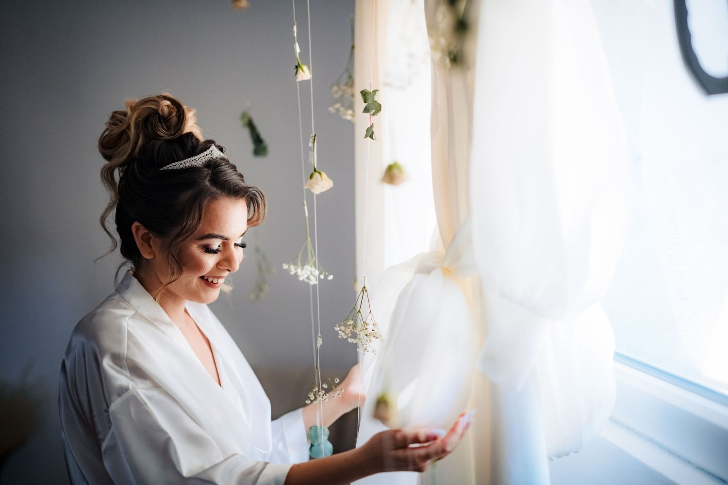 Natural light illuminates intimate getting ready moments before the wedding ceremony.