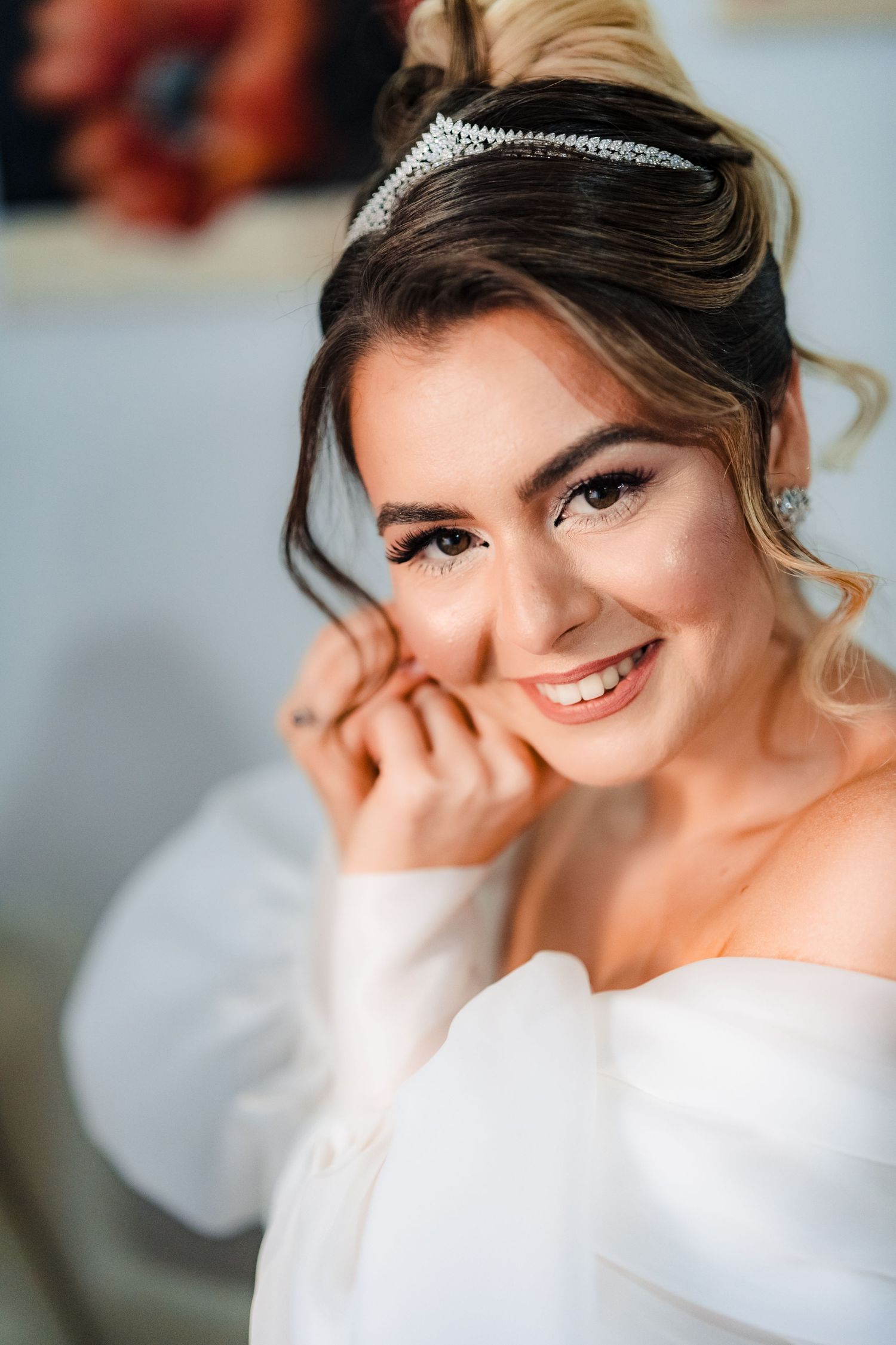 Playful bridal portraits showing joyful expressions against light background.