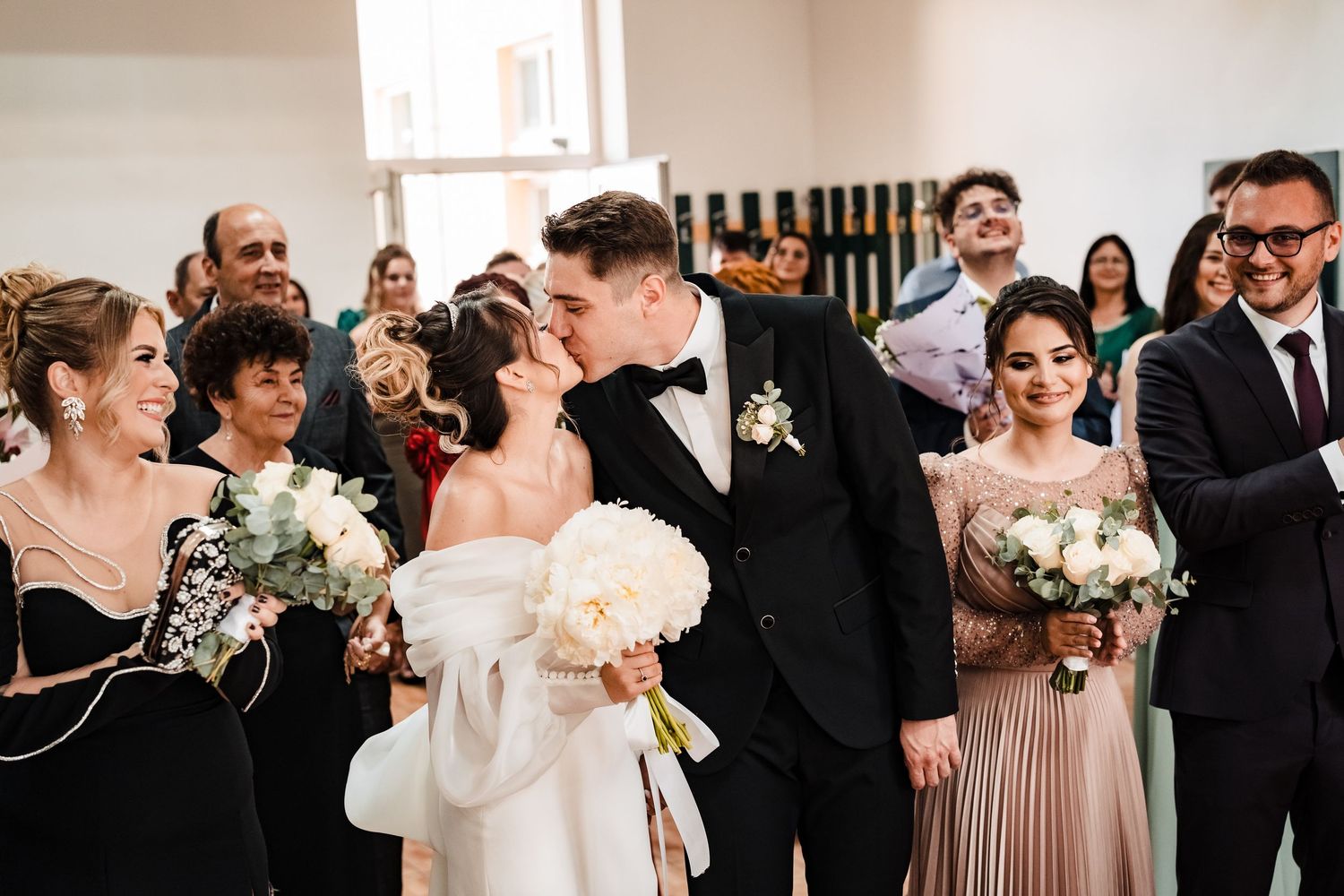 Wedding party members sharing joyful moments during reception celebration.