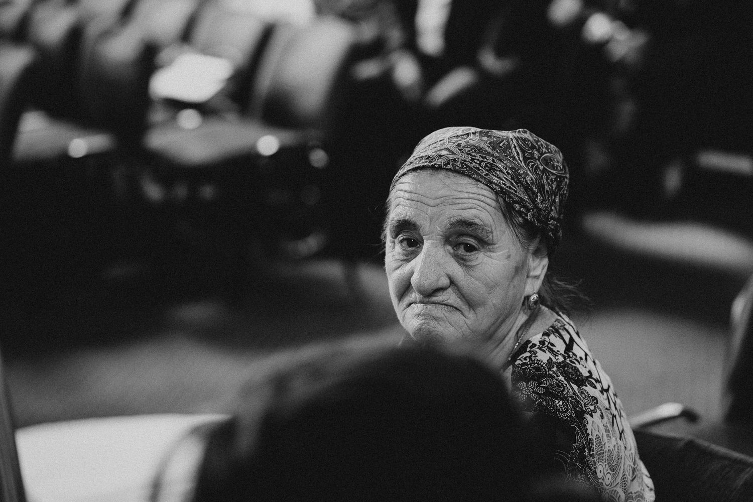 Emotional wedding ceremony moment captured in black and white at an ornate church.