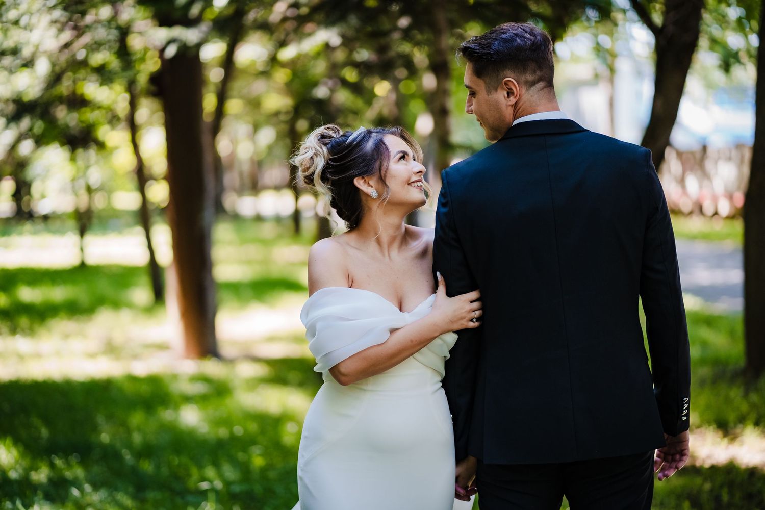 Candid wedding photography sequence showing tender moments in a wooded park.