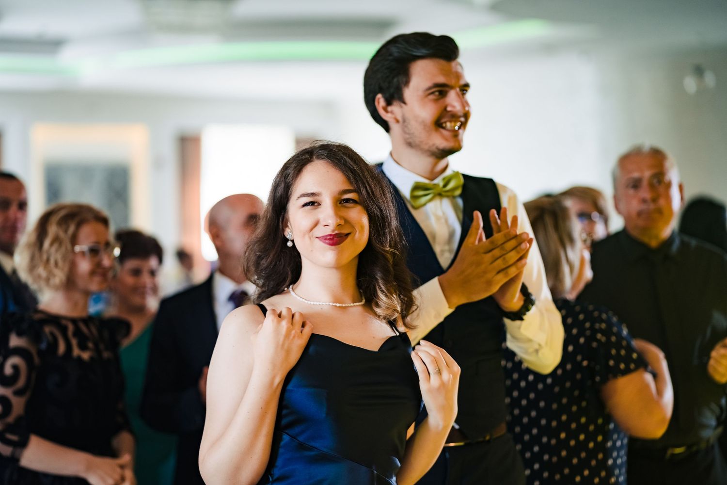 Wedding guests dance and celebrate during a lively reception party.