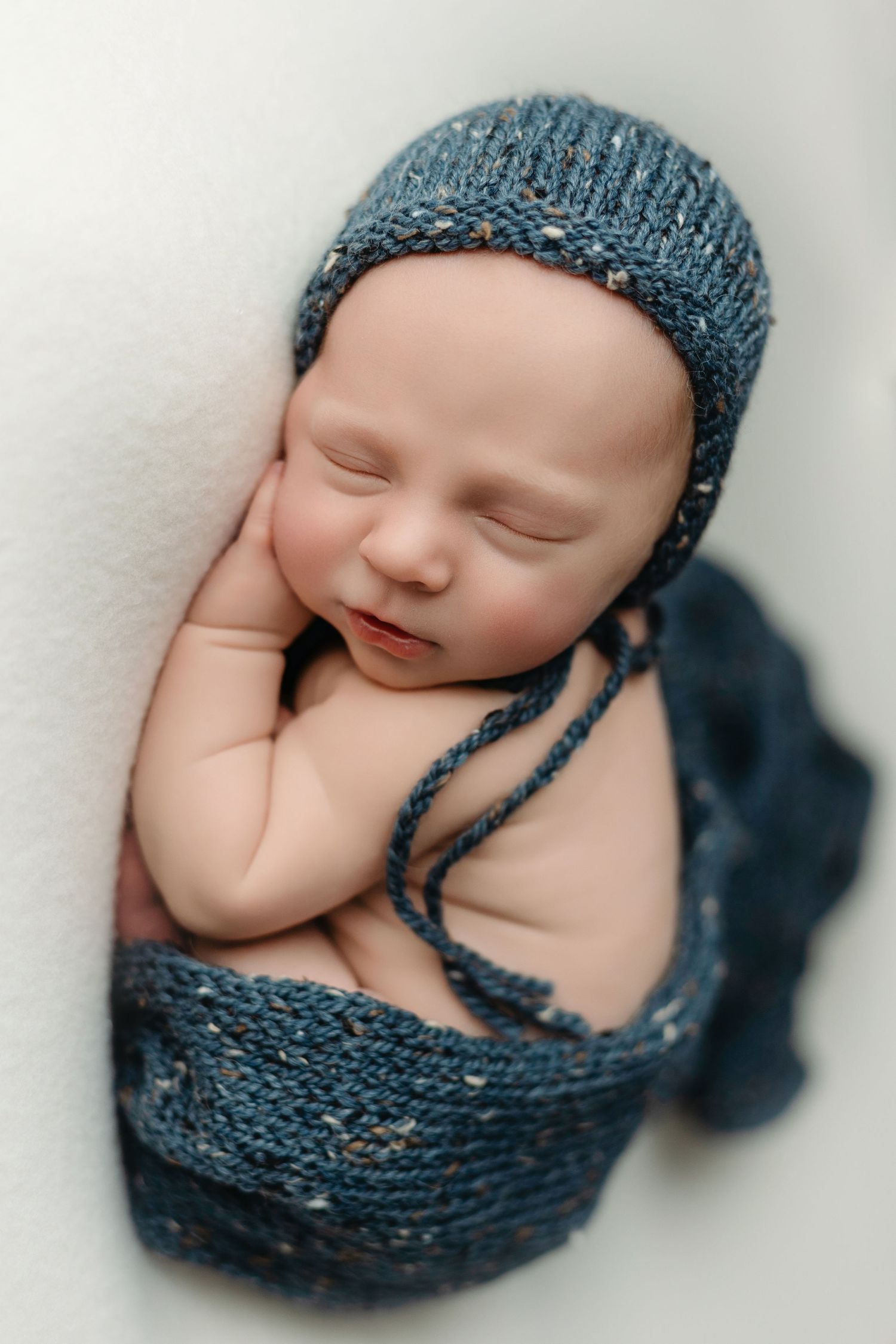 Newborn baby boy wearing a blue hat and wrap. Greenville SC newborn photographer, Easley SC newborn photographer