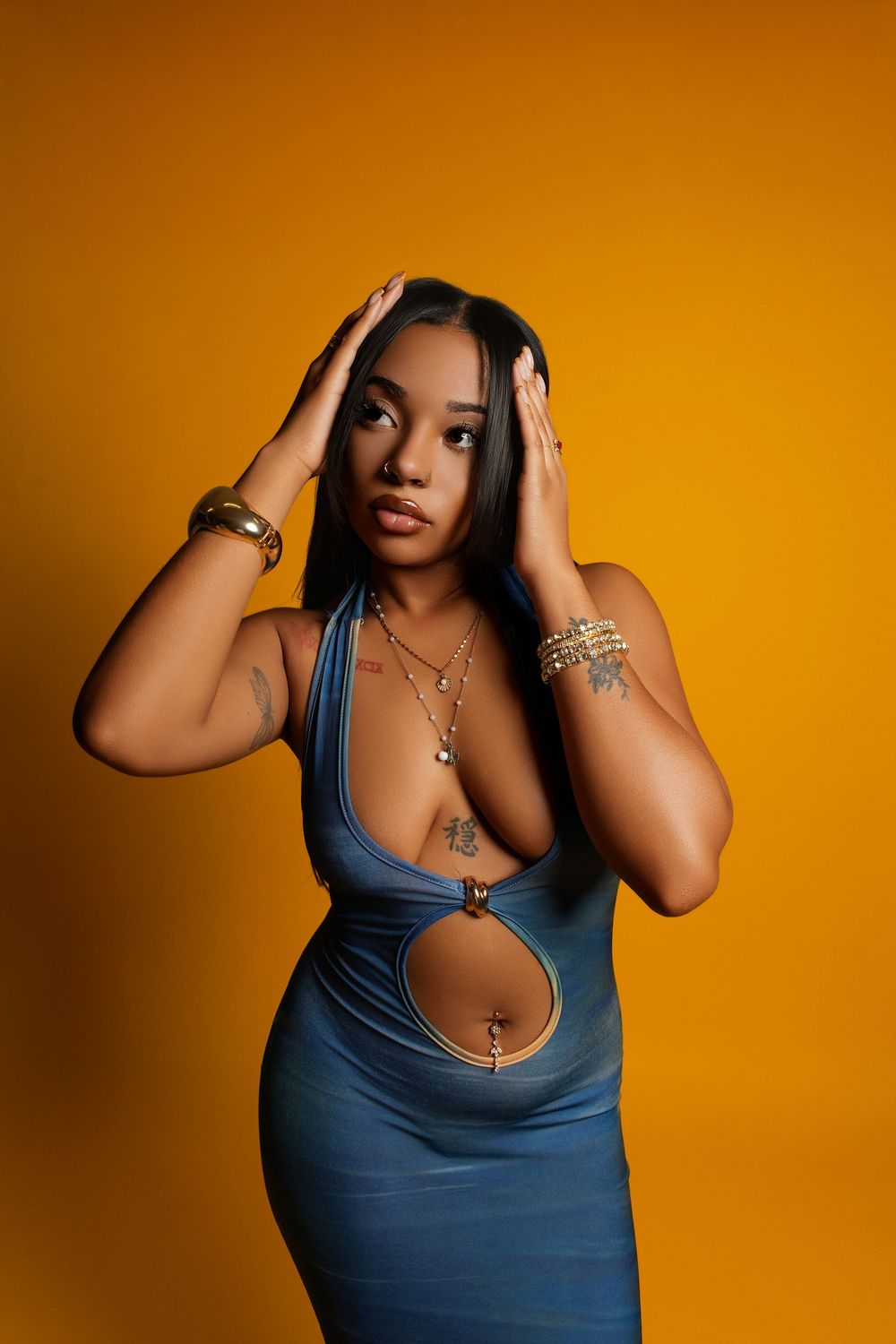 Fashion portrait series showing poses in blue tank top against warm orange studio background.