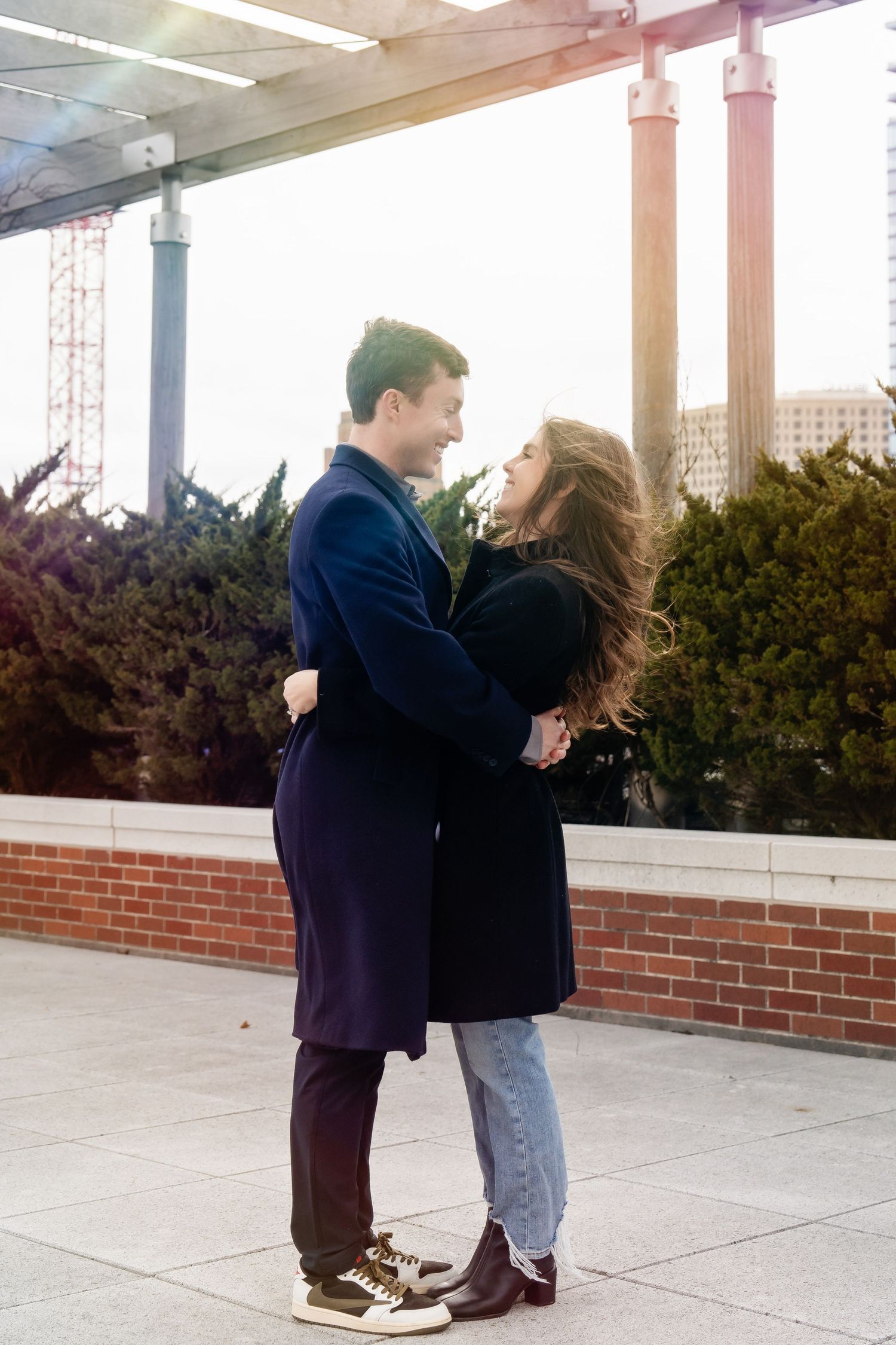 Photo of a couple gazing at each other backlit with a rainbow sunburst taken by Milwaukee family photographer Rachel Dickman.