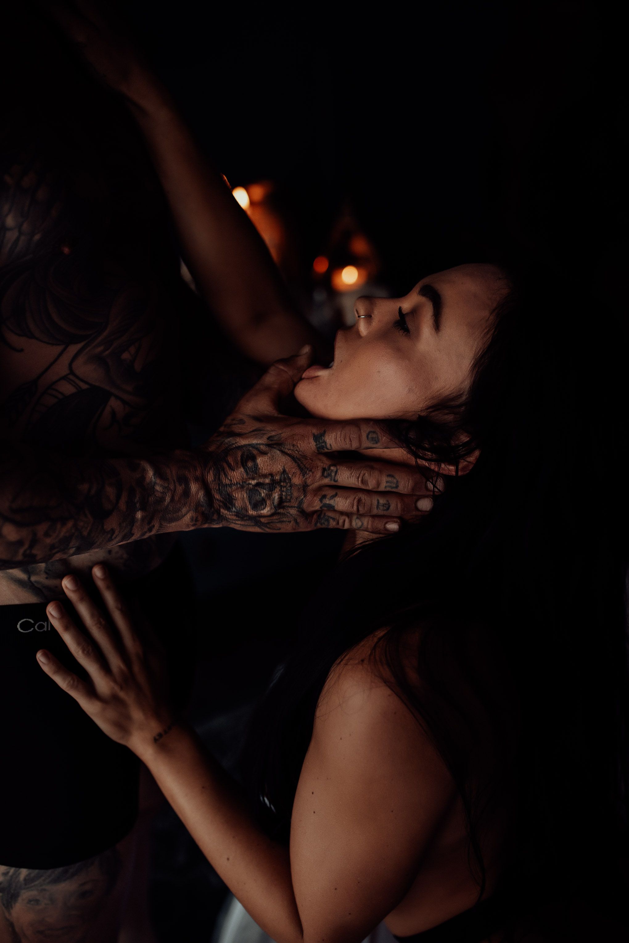 Moody artistic romantic photo in dark setting with dramatic lighting and shadow effect.