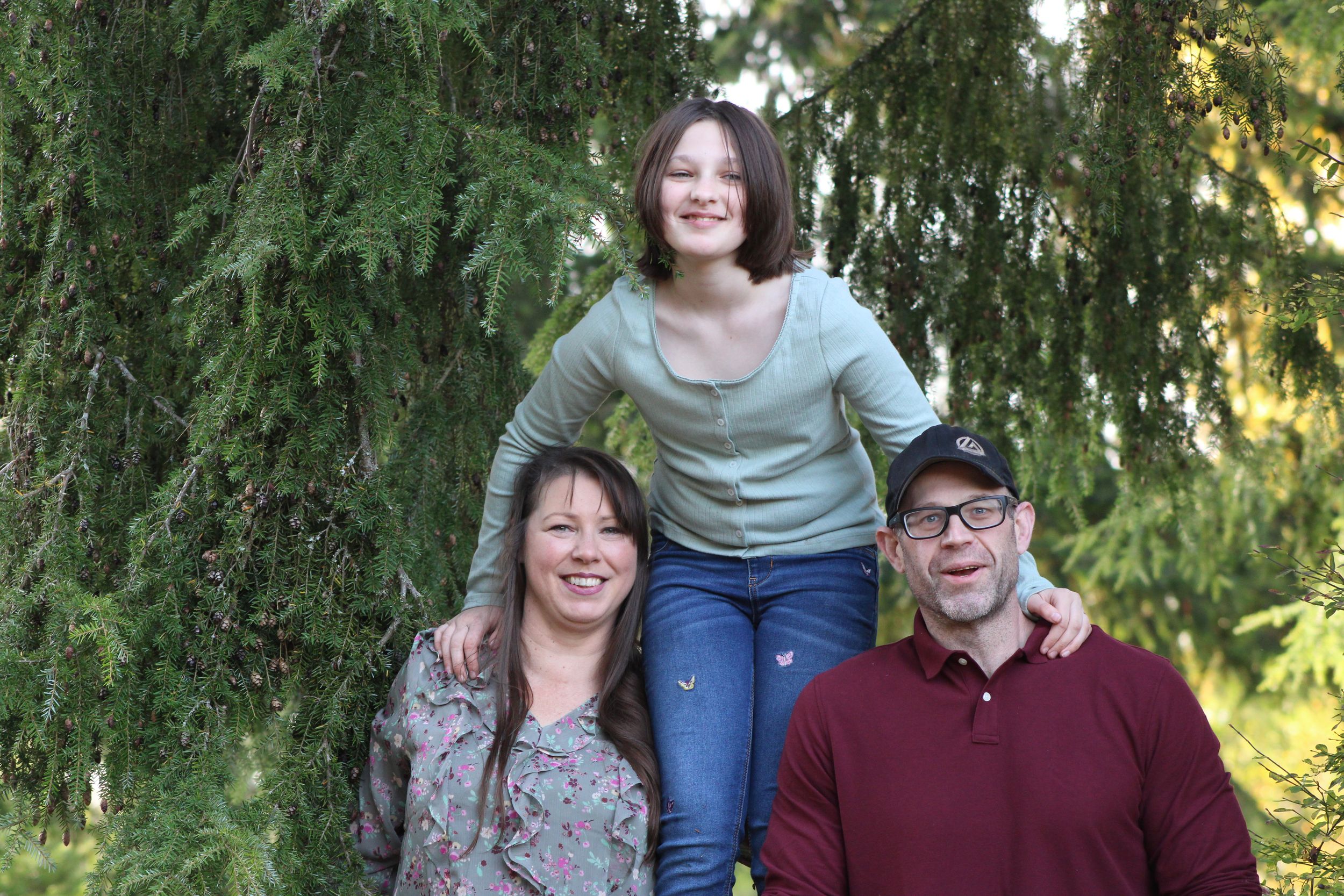 Family sharing a playful and connected moment together during an outdoor family photo session