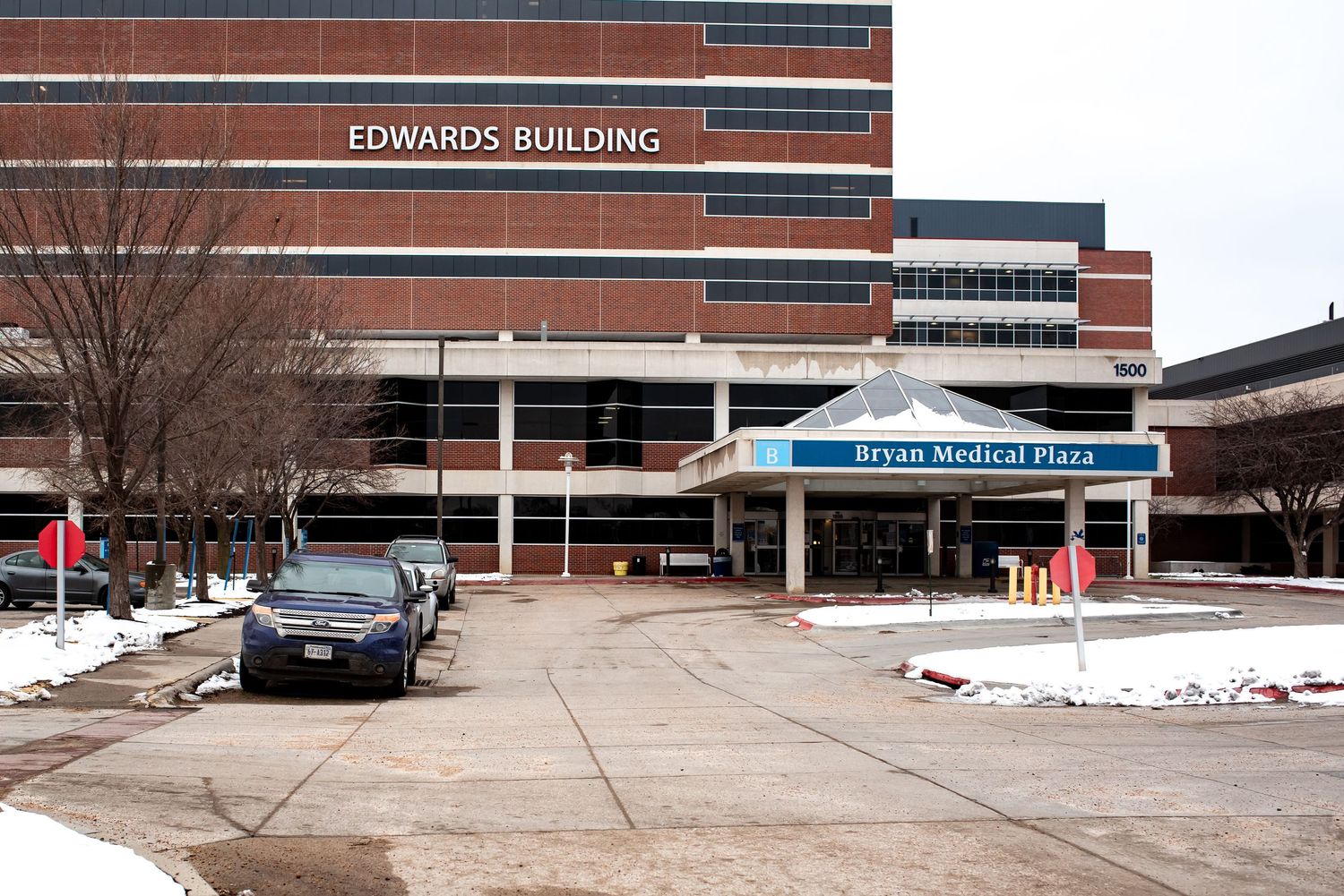 Exterior view of Bryan Hospital medical facility entrance with snow on ground.