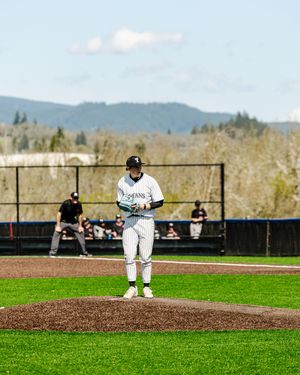 Titans baseball pitcher standing on the mound preparing to deliver a pitch on a sunny day.