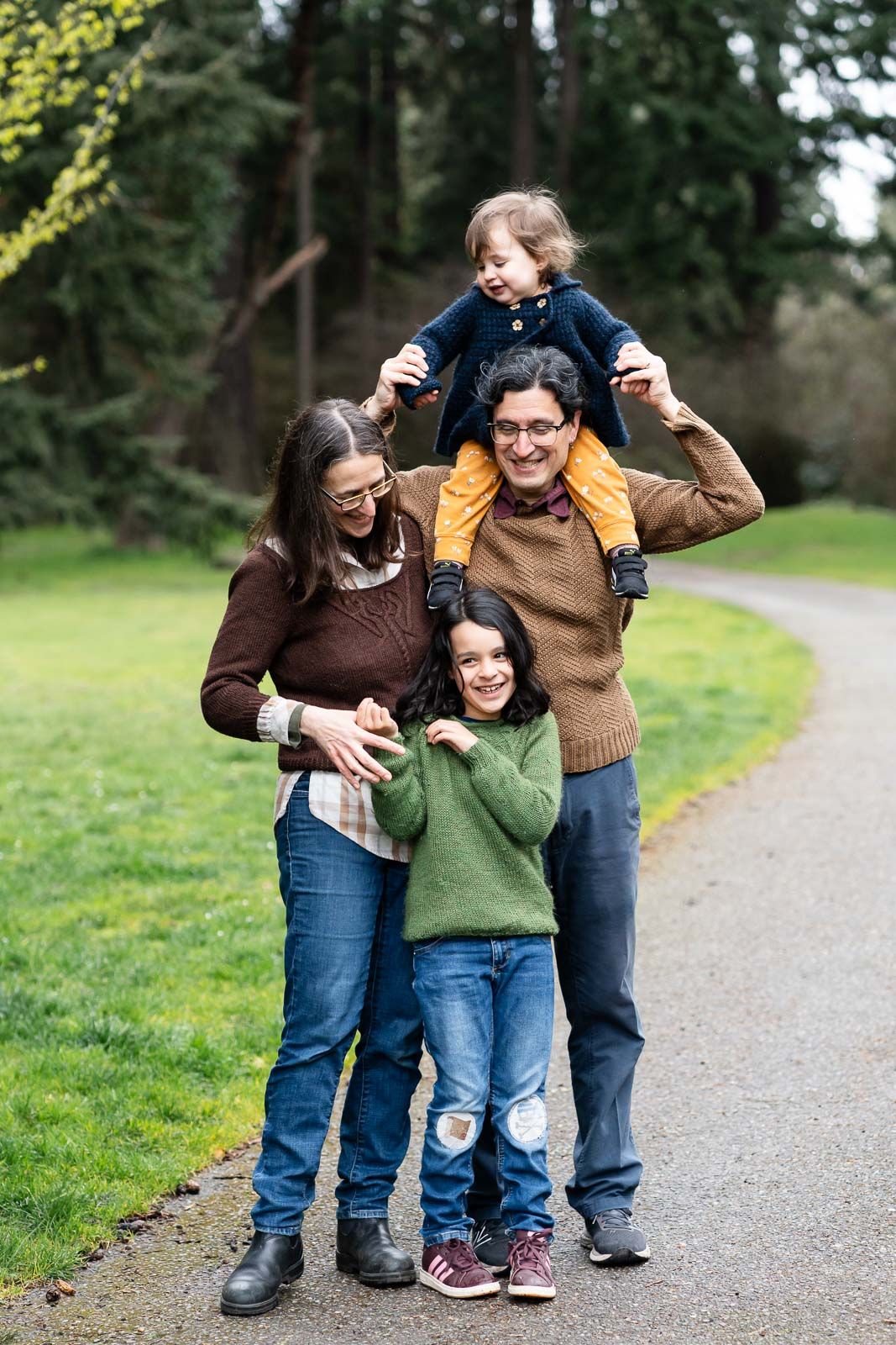 Family tickling each other and smiling.