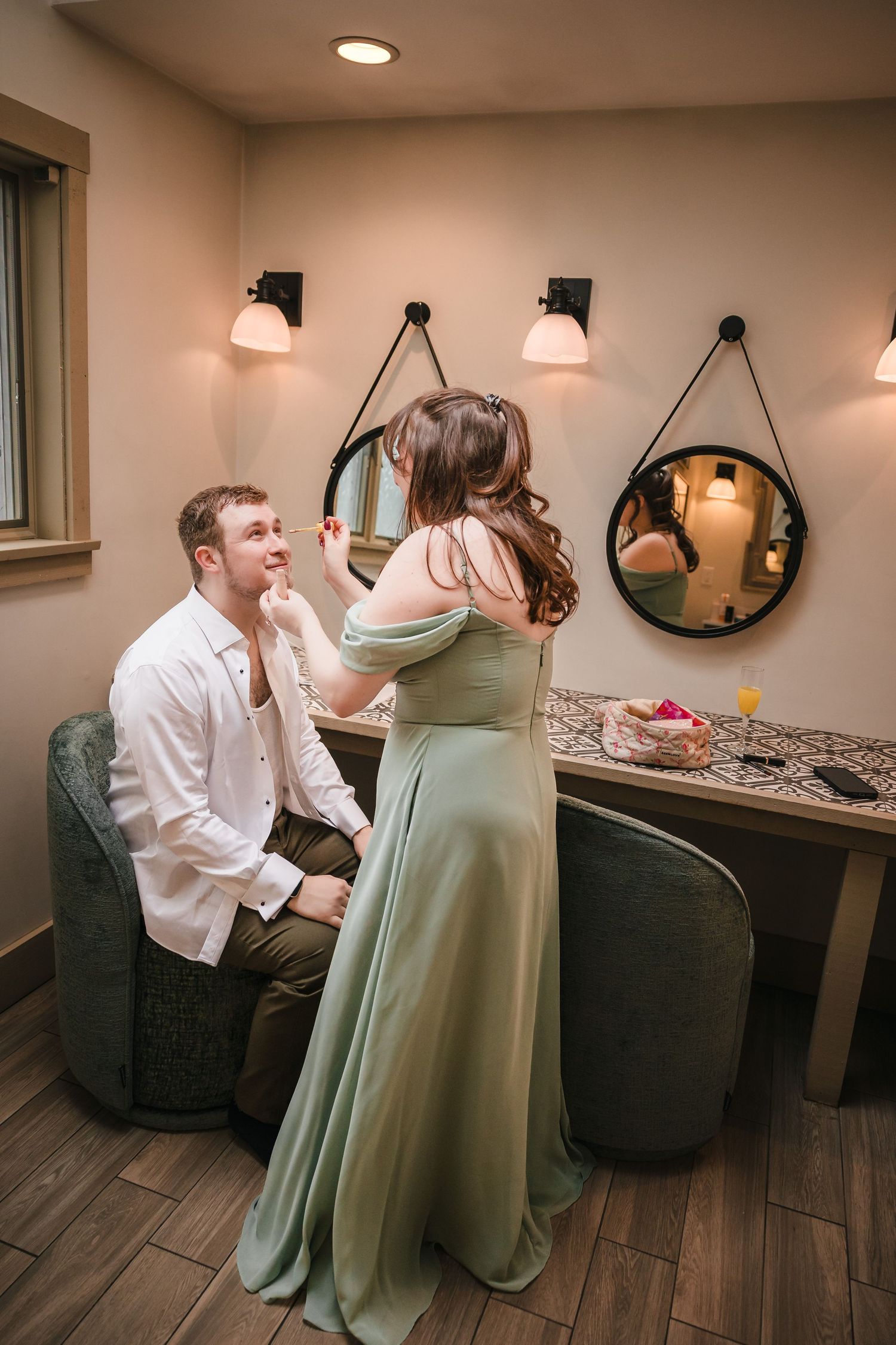 Groom getting ready with maid of honor at Briar Barn Inn wedding in Rowley Massachusetts