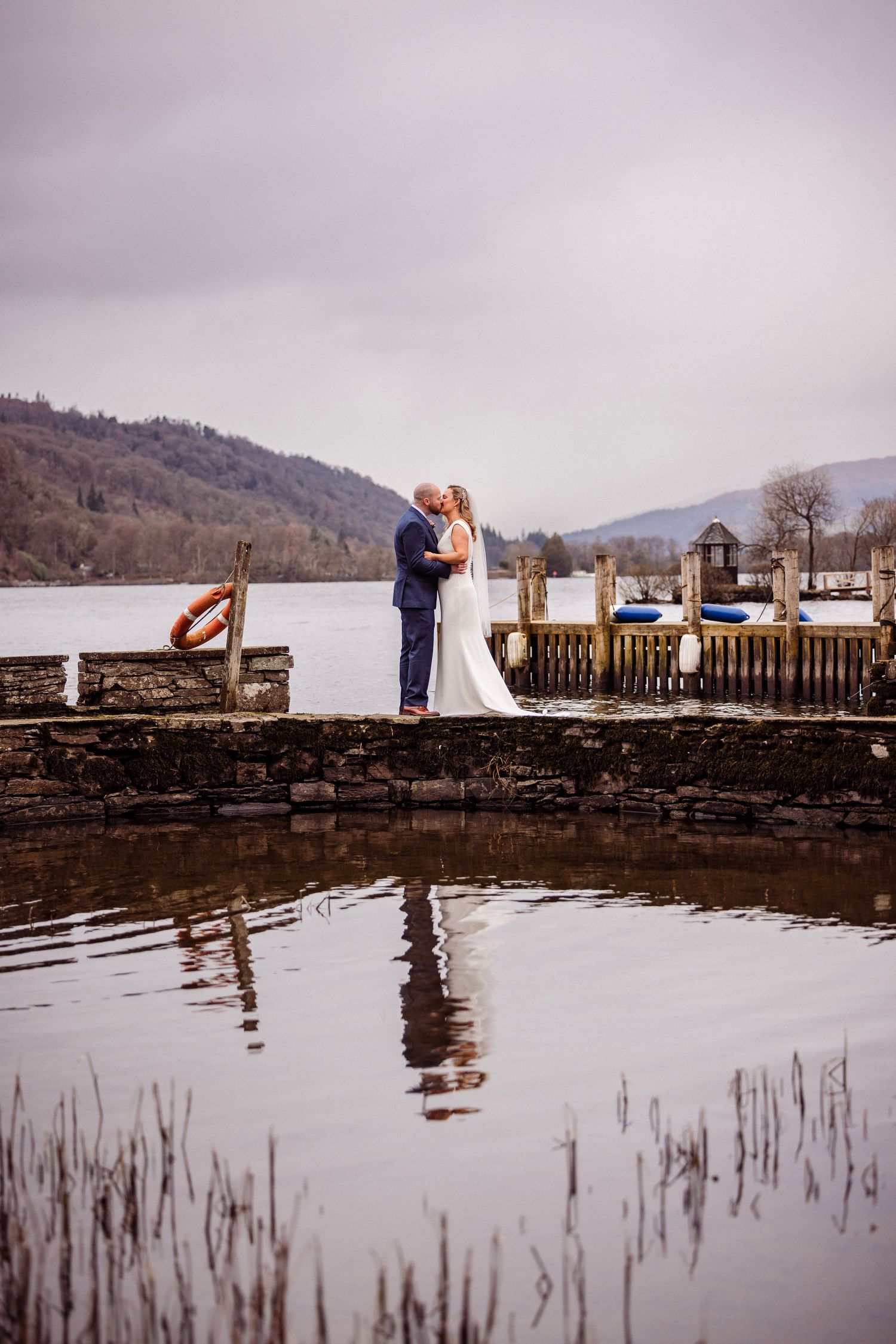 Couple reflected in water during portraits at Storrs Hall