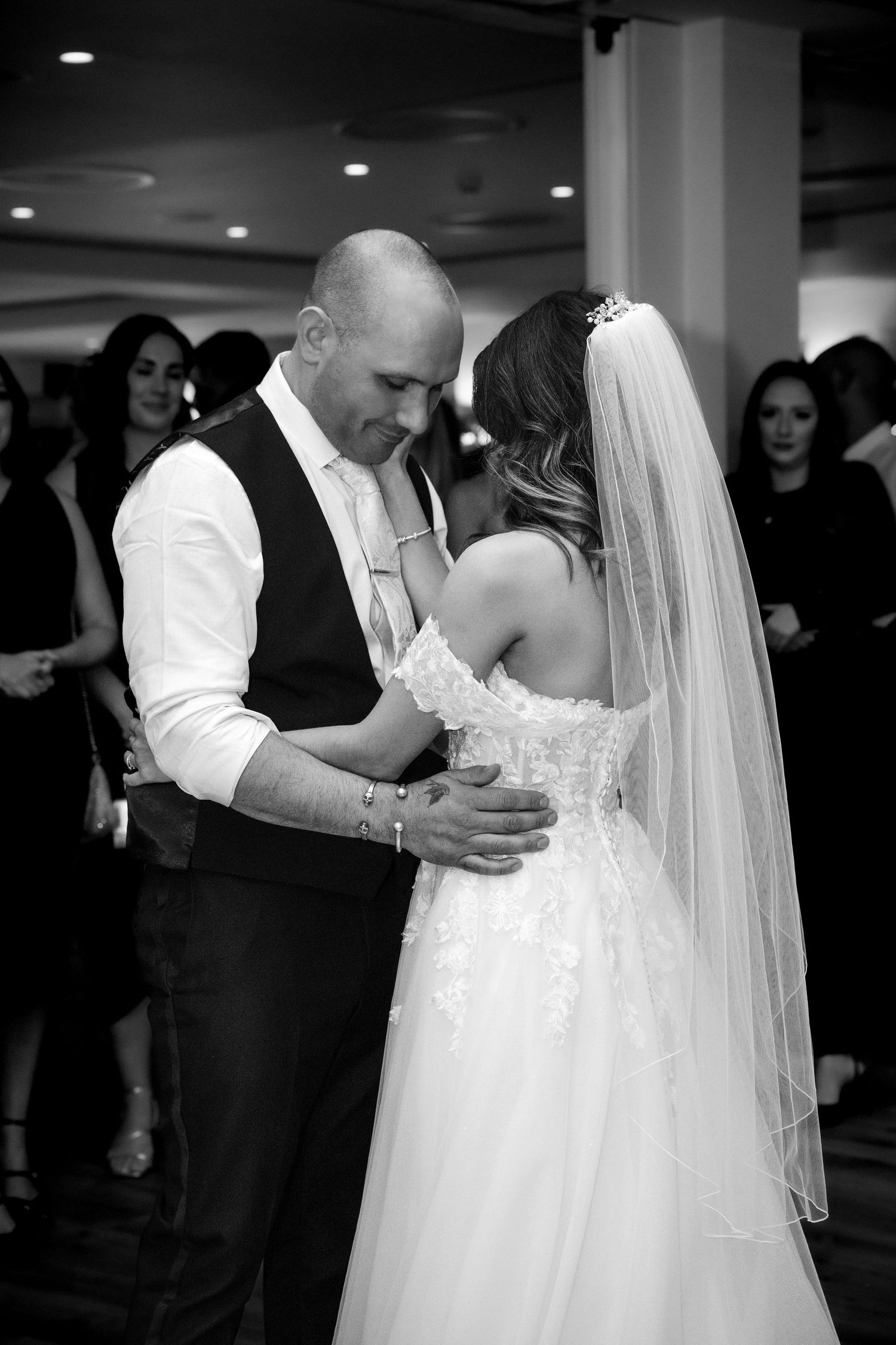 Bride and groom sharing their first dance in black and white at their wedding reception.