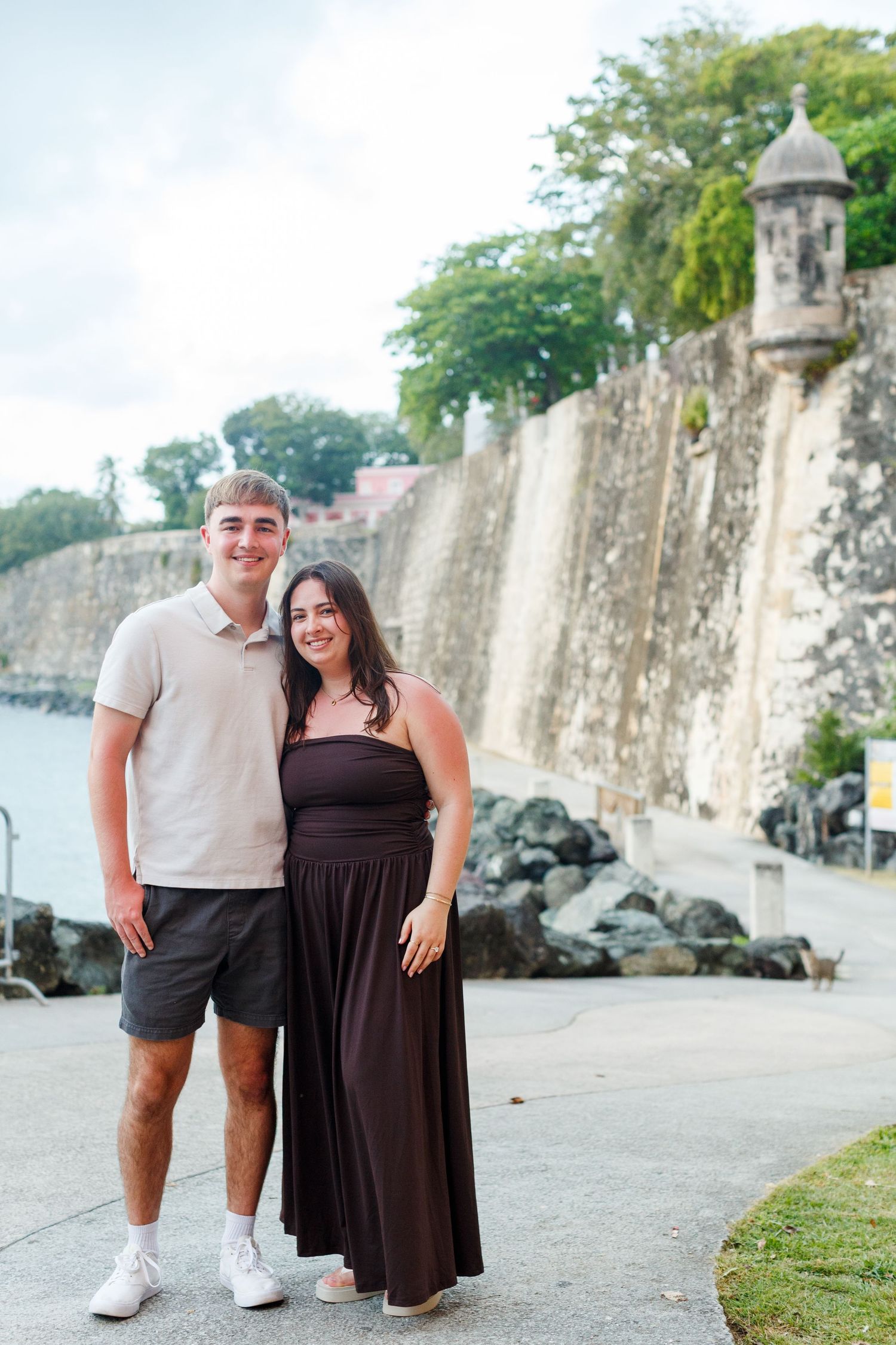 Couples portrait along the Paseo de la Princesa in front of the Puerta de San Juan in Old San Juan, Puerto Rico.