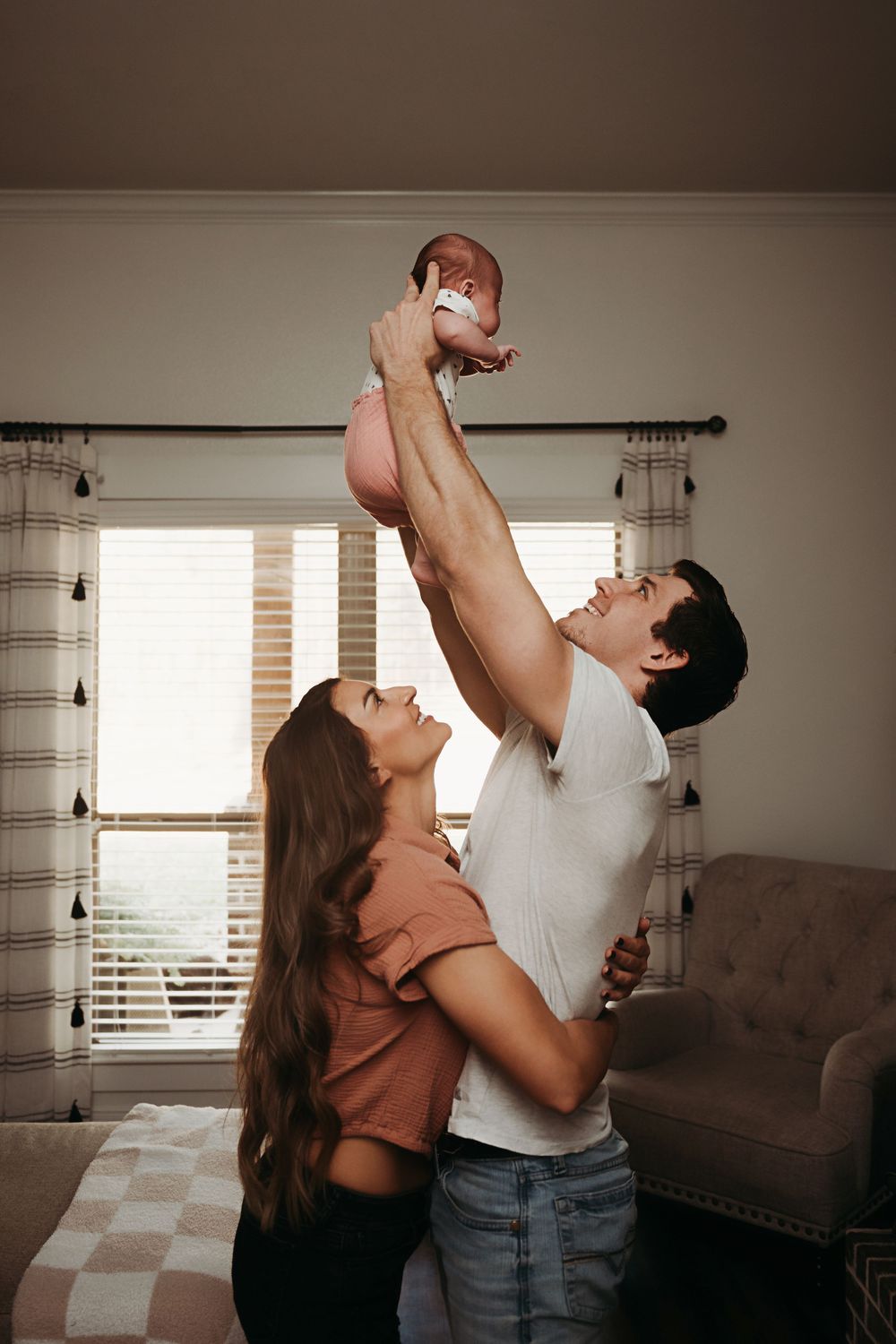 A sequence of joyful moments captured between parent and baby playing together in a living room with natural light.