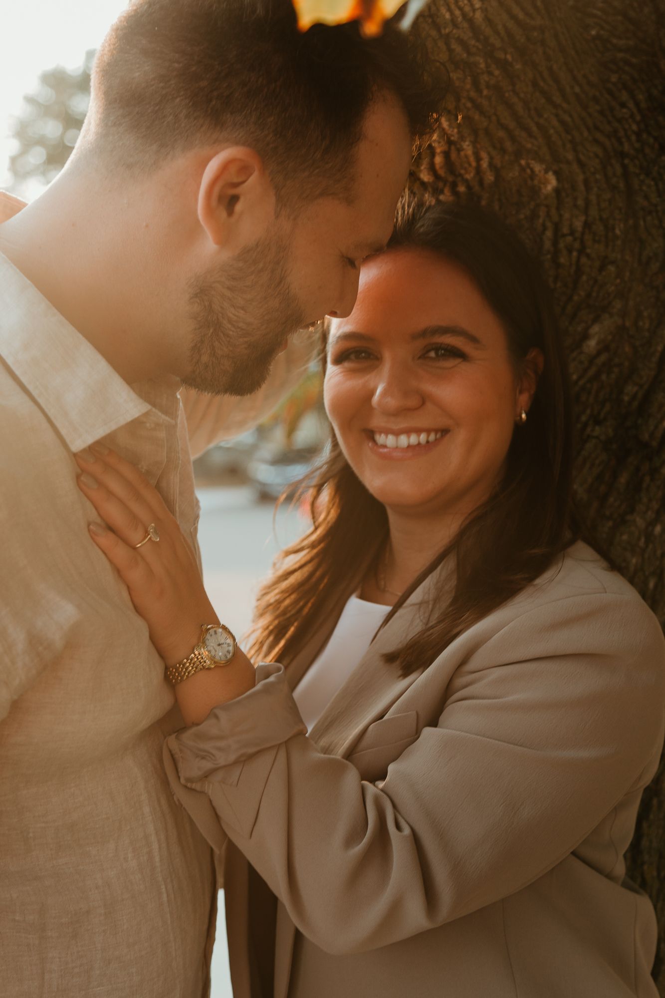 A romantic couple shares intimate moments in a series of warm-toned photos against a natural backdrop.