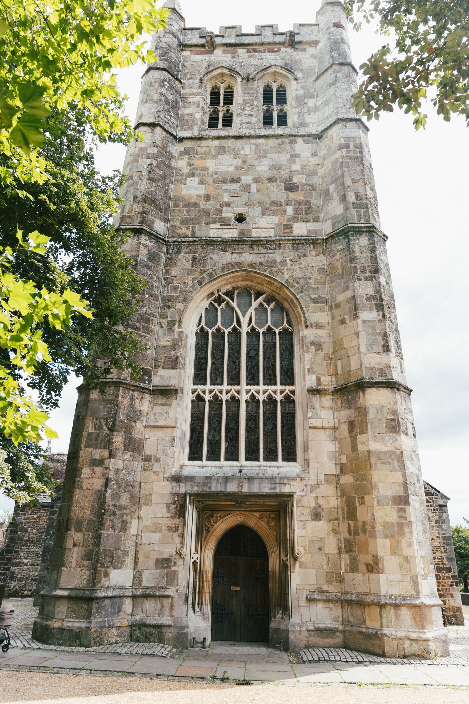 Historic stone church exterior with gothic windows and arched doorway.