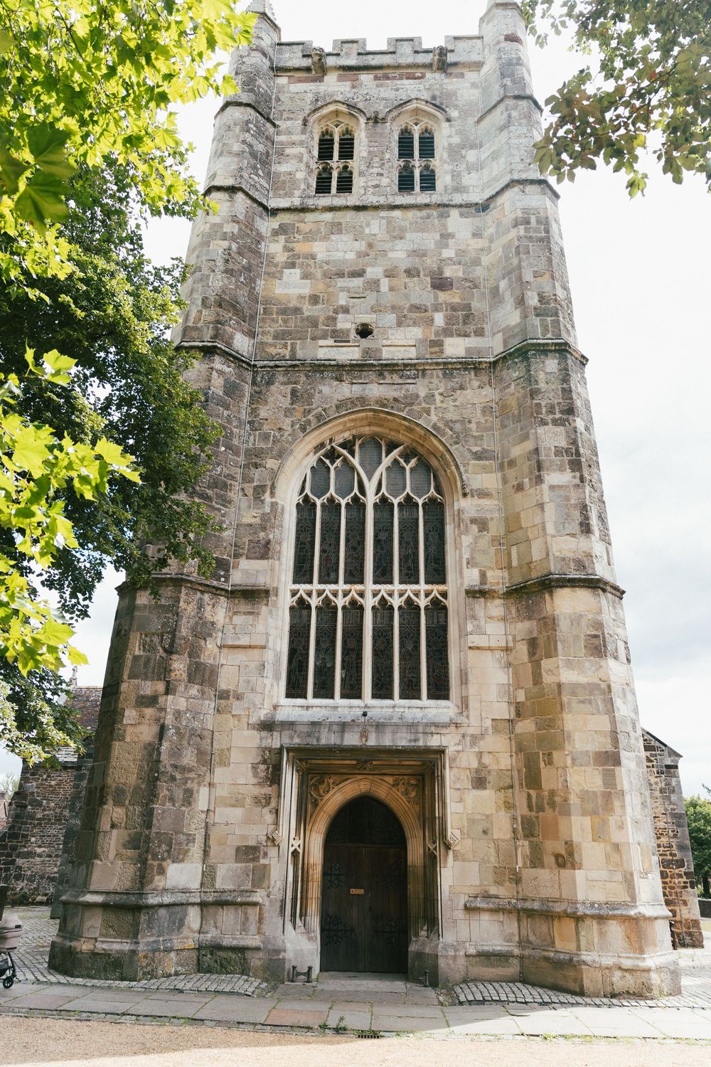 Historic stone church exterior with gothic windows and arched doorway.
