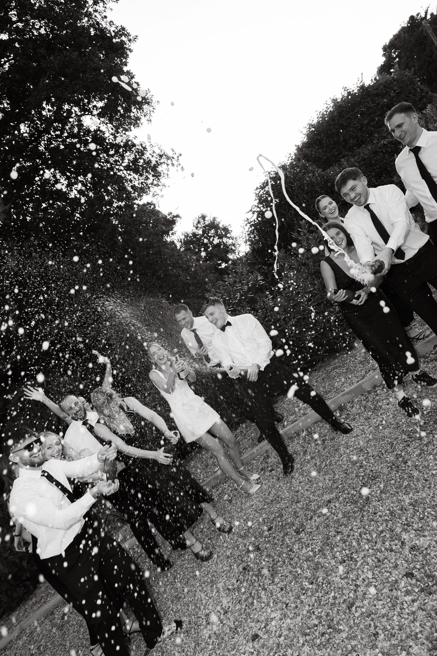 Black and white photos of people celebrating outdoors with dramatic lighting effects.