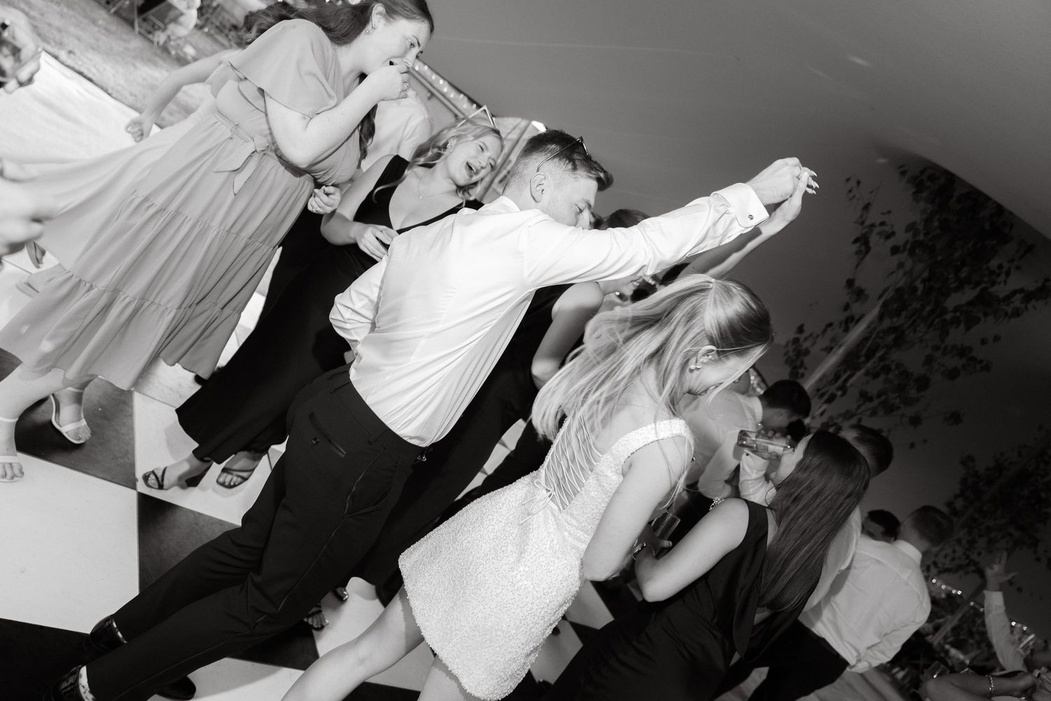 A sequence of black and white shots capturing lively party moments.