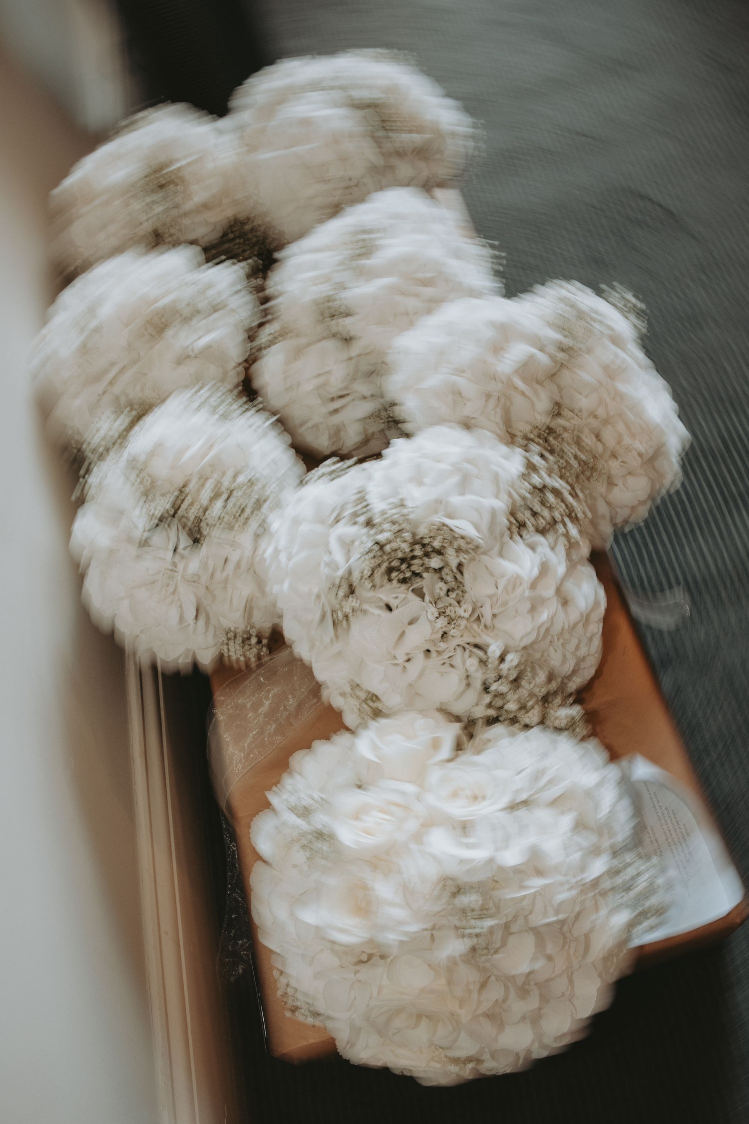 Close-up of white fluffy peony bouquet with soft, delicate petals.