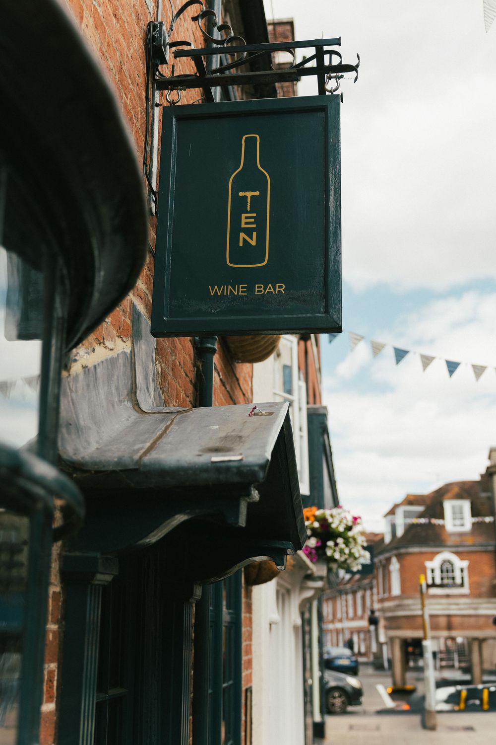 Vintage wine bar signage mounted on brick building exterior.
