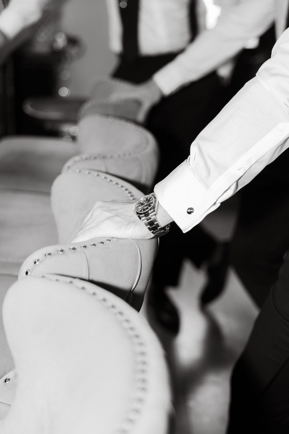 Close-up detail of formal white dress shoes at a wedding.