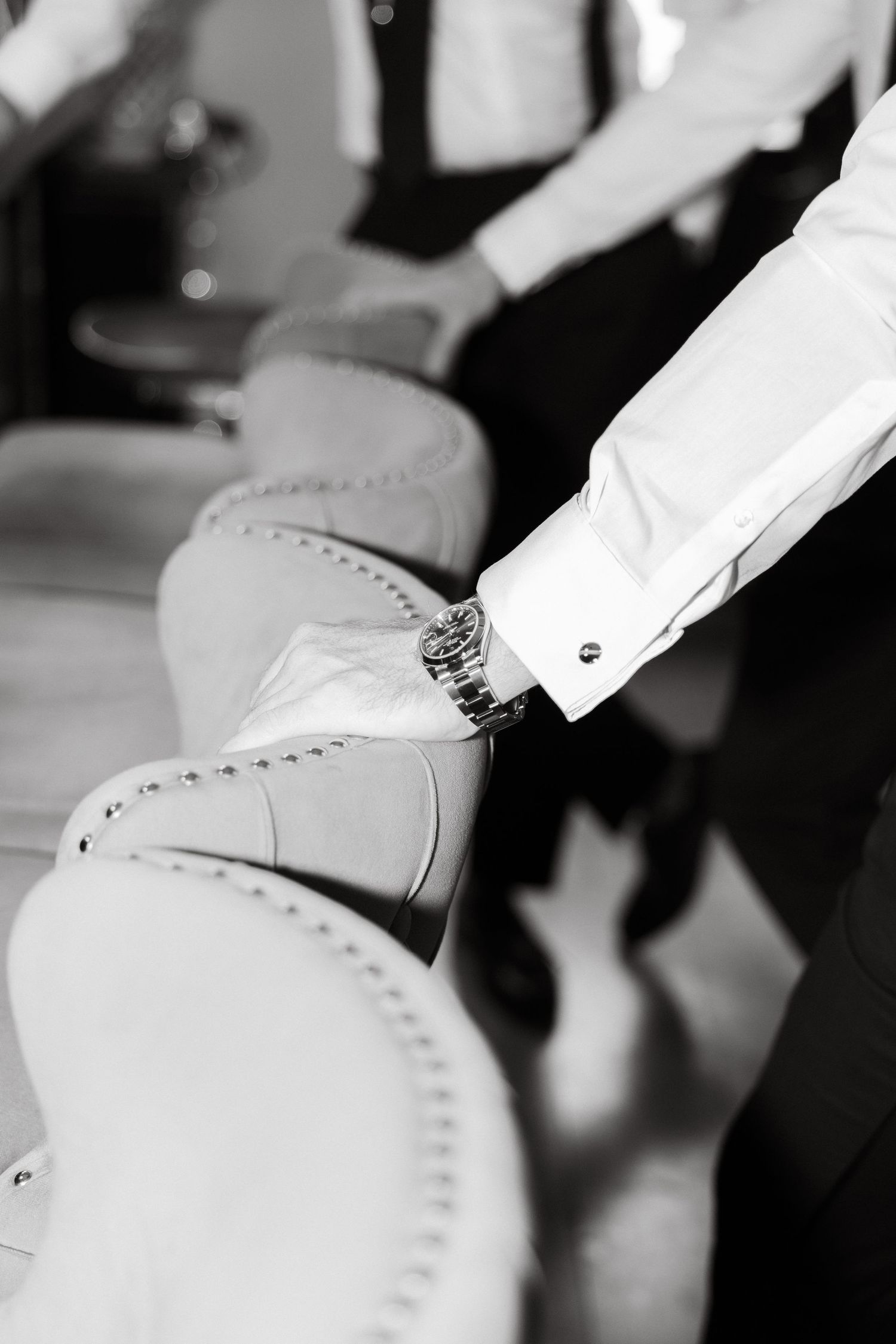 Close-up detail of formal white dress shoes at a wedding.