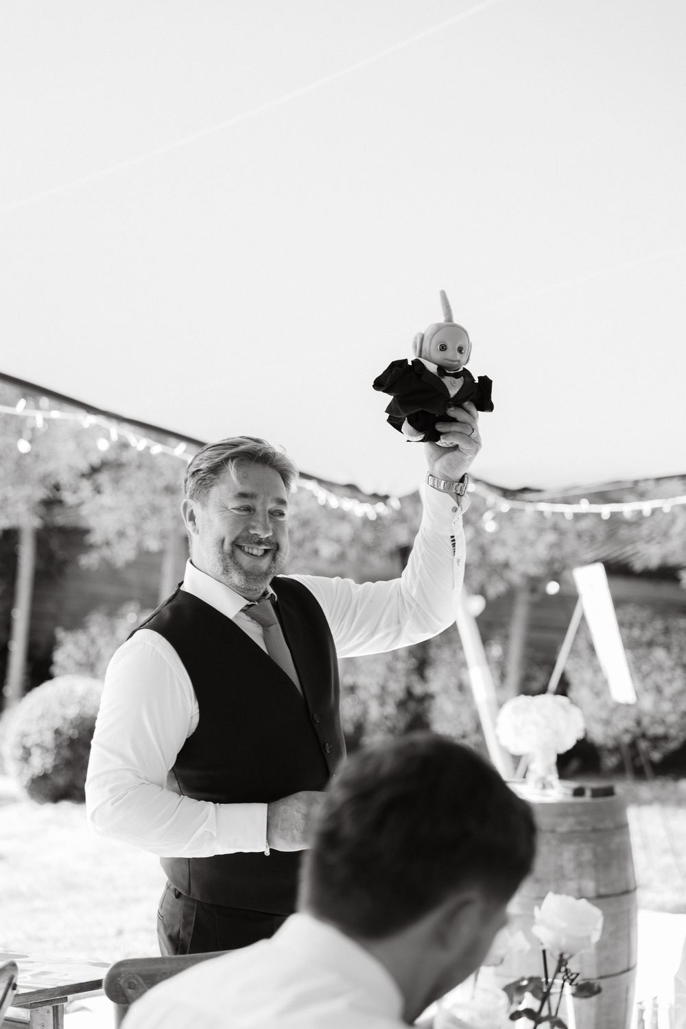 Black and white sequence showing celebratory moments at an outdoor party.