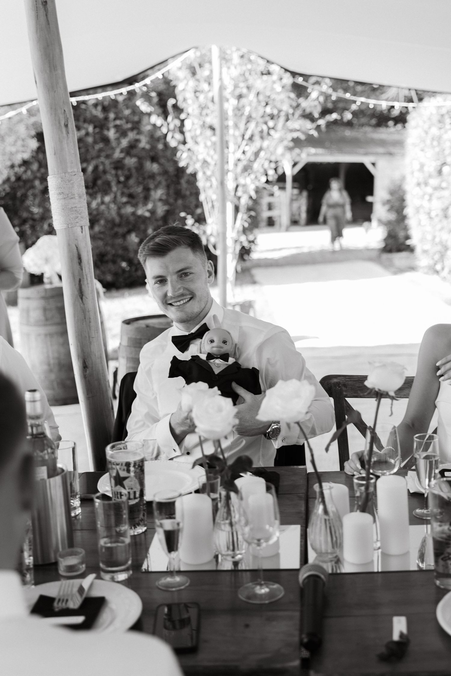 Bartenders preparing drinks at an outdoor bar during a celebration event.