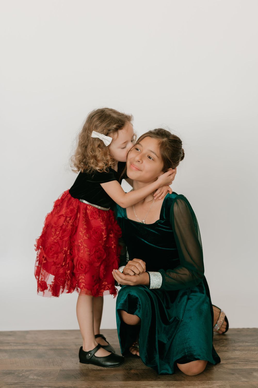 A sweet moment captured in a series of black and white photos showing tender affection between parent and child.
