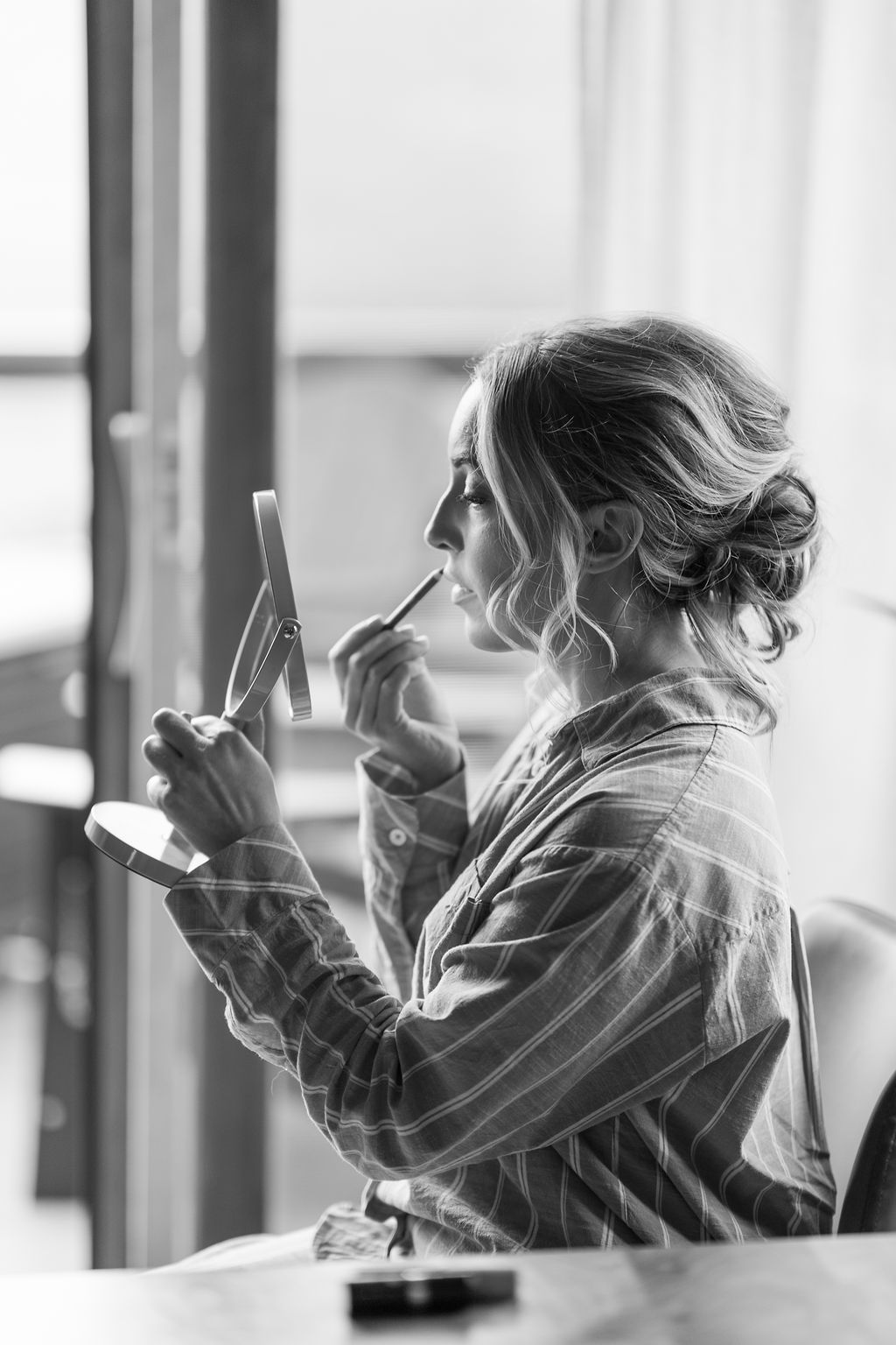 A series of black and white photos showing someone with blonde hair looking at a mobile phone in different poses.