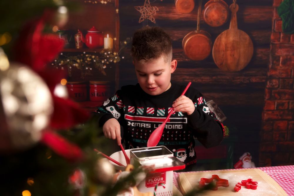A cozy Christmas scene with red and white decorations, wooden barrels, and festive holiday lighting in a rustic setting.