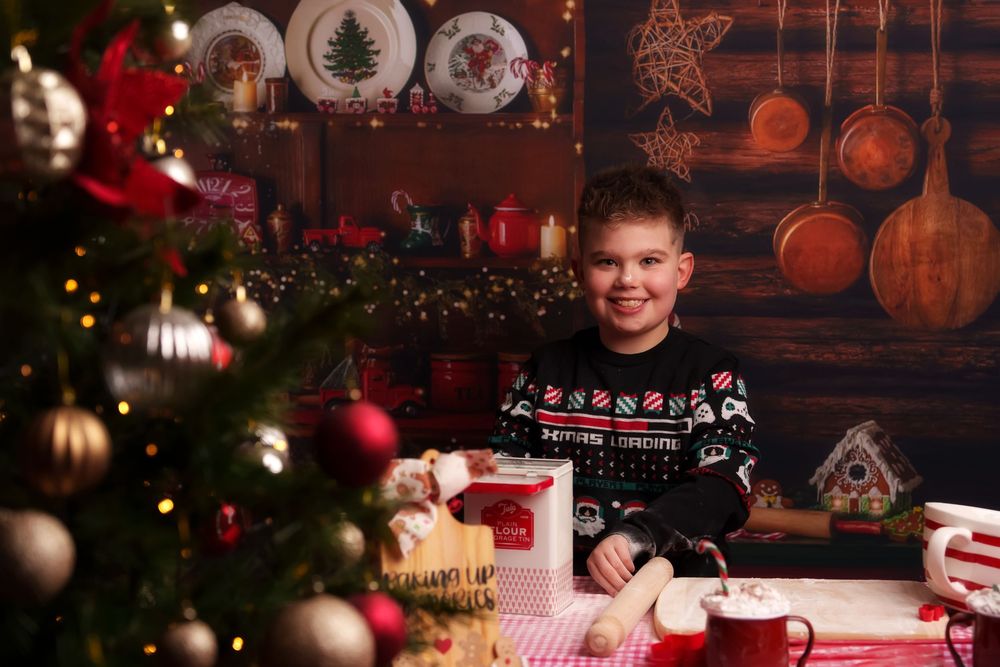 A festive Christmas scene with a decorated tree, rustic wood walls, and red holiday ornaments in warm lighting.