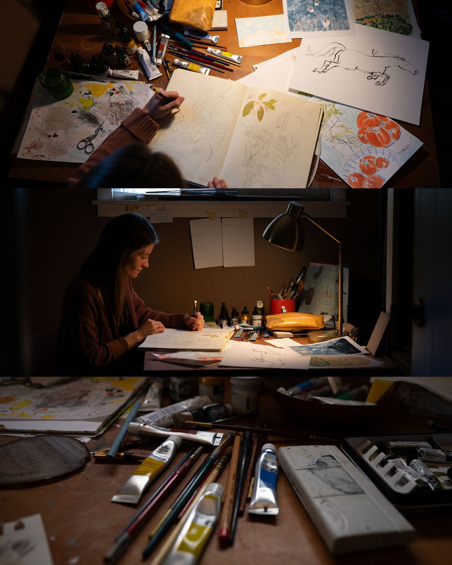 Artists work at illuminated desks in a dimly lit studio space creating illustrations and drawings.