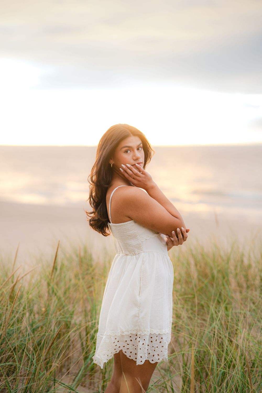 Dreamy sunset portraits in a field with tall grass and soft golden light.