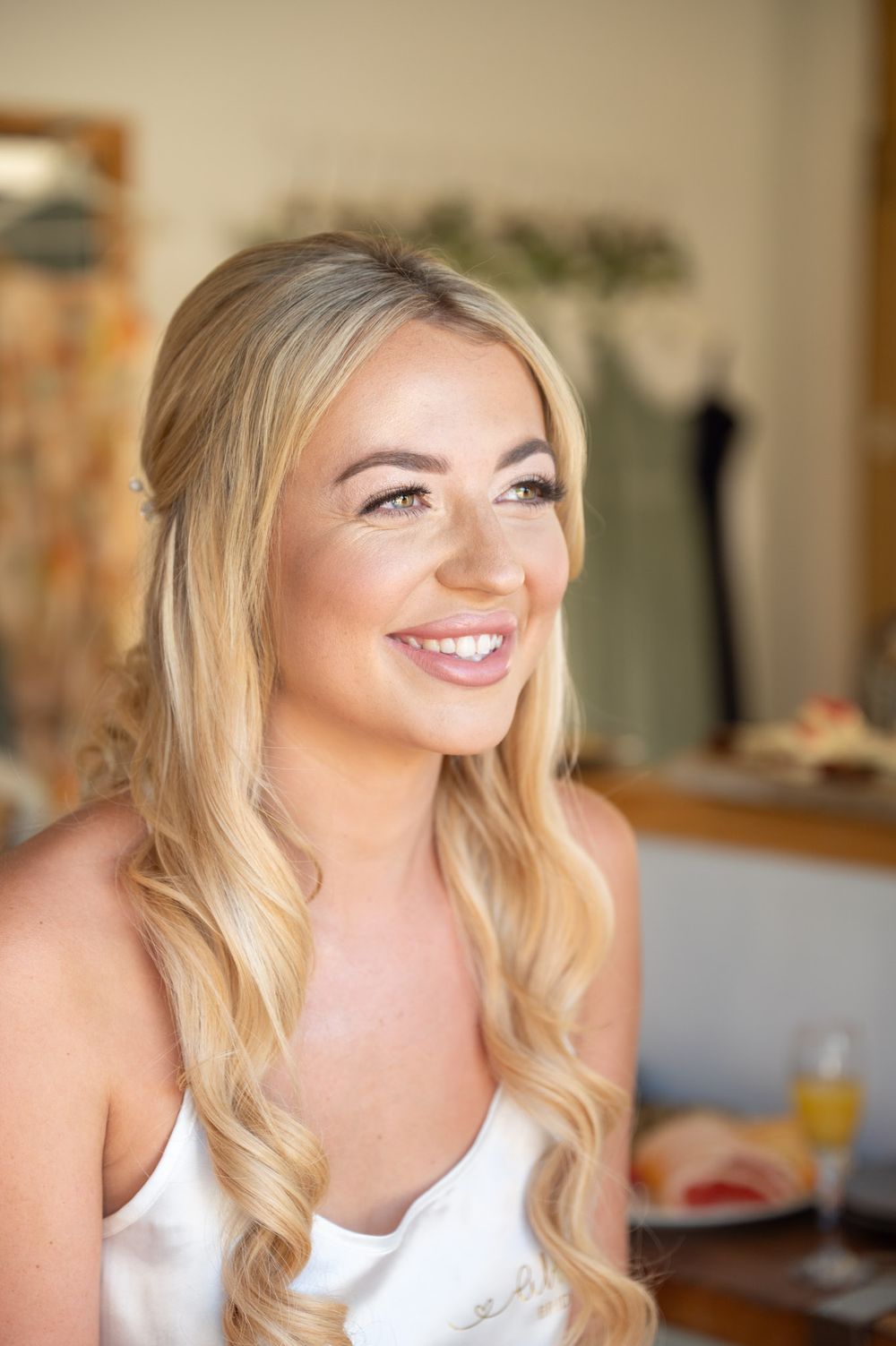 A portrait of a bride as she gets ready for her wedding ceremony at Cooling Castle Barn.