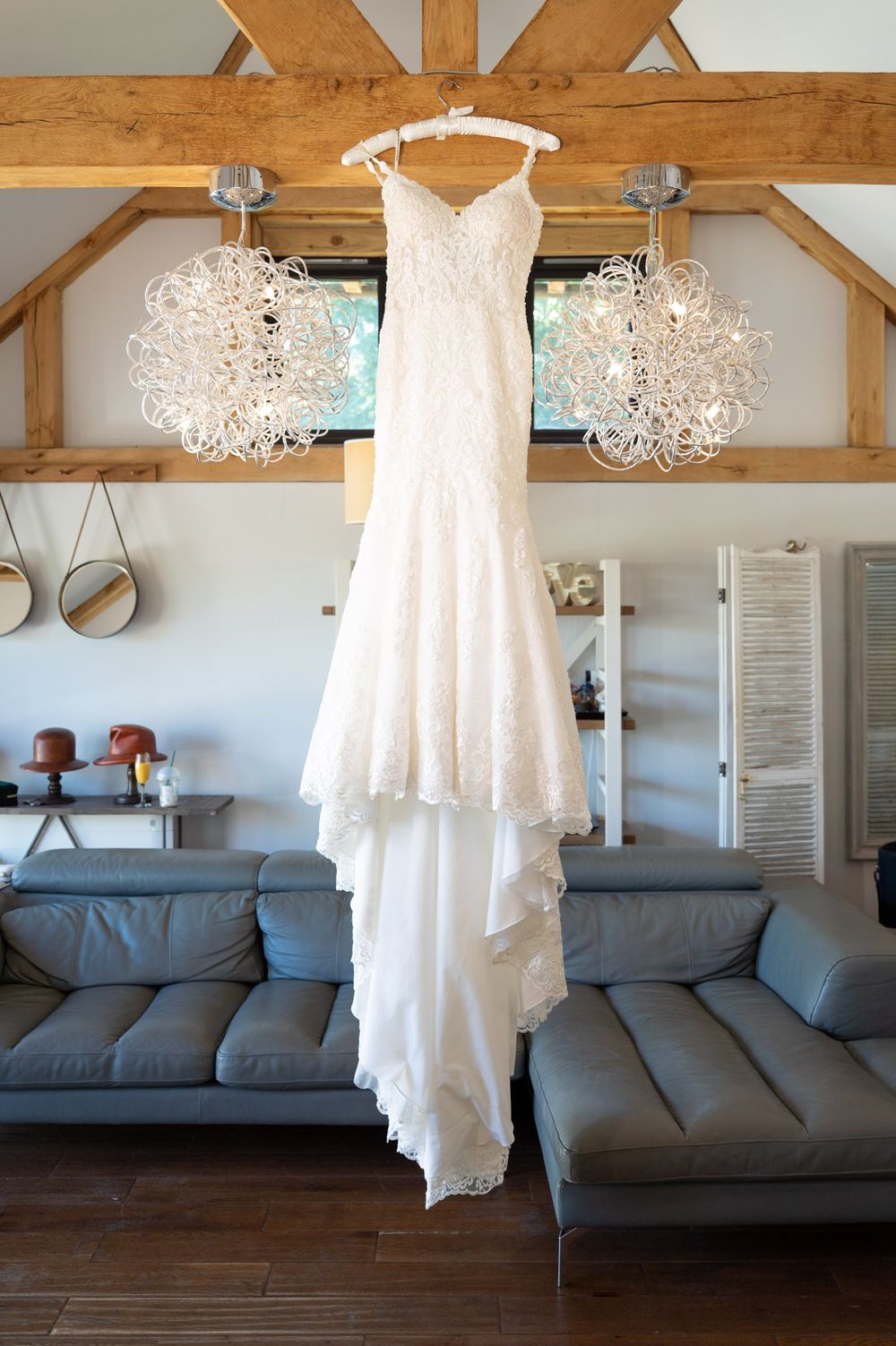 The brides dress hanging in the bride prep room at Cooling Castle in Kent.