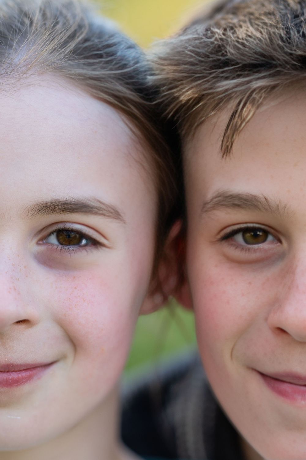 A cropped series of partial facial features showing eyes, noses and smiles against a soft blurred background.