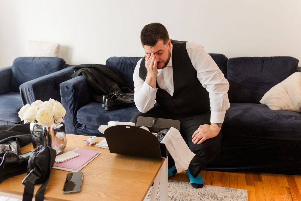Person doing a series of push-up exercises on a wooden floor next to a dark couch.