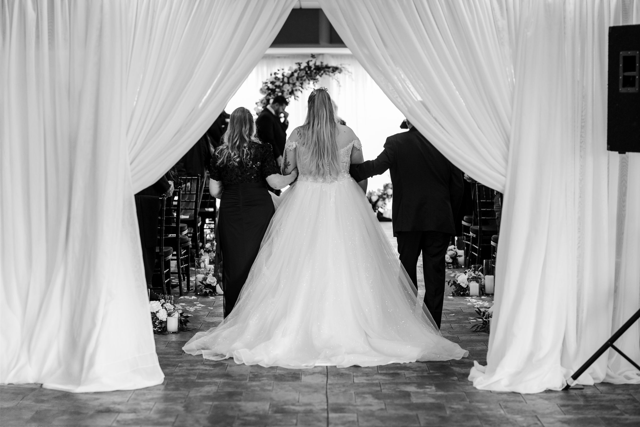 A series of wedding dress photos showing elegant white gowns with full skirts and trains arranged in a row.