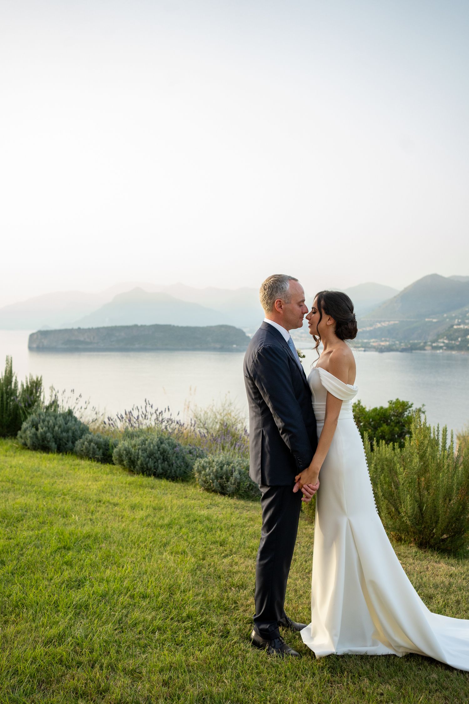 Scenic coastal wedding photography with Mediterranean sea views in the background.