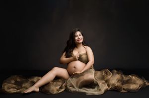Artistic boudoir photo series showing a figure posed elegantly with draped brown fabric in different positions.