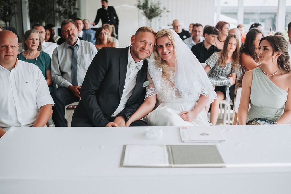 Wedding guests share emotional reactions during a special moment at an elegant reception celebration.