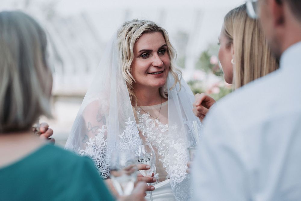 Bride and groom share intimate moments during their wedding celebration in a series of candid photos.