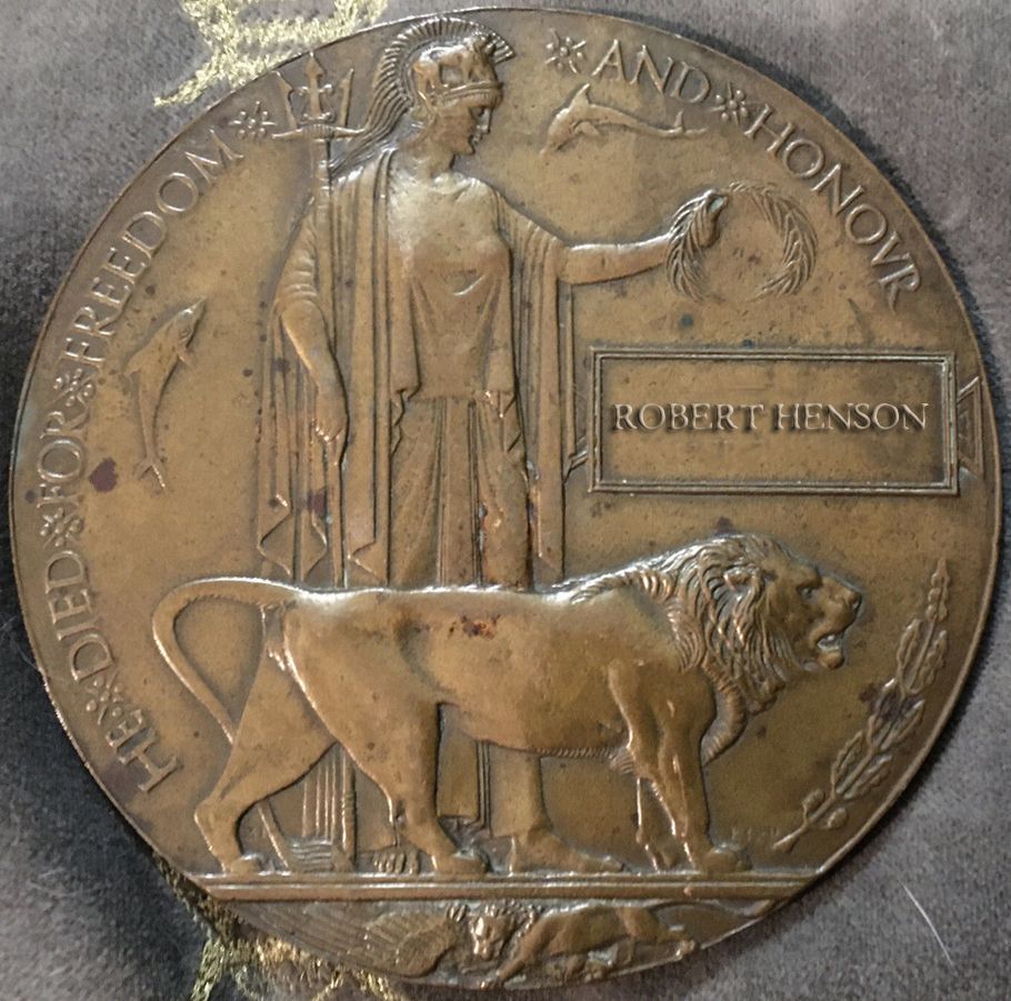 Vintage bronze medallion showing a person and animals in silhouette against a textured background with decorative elements.