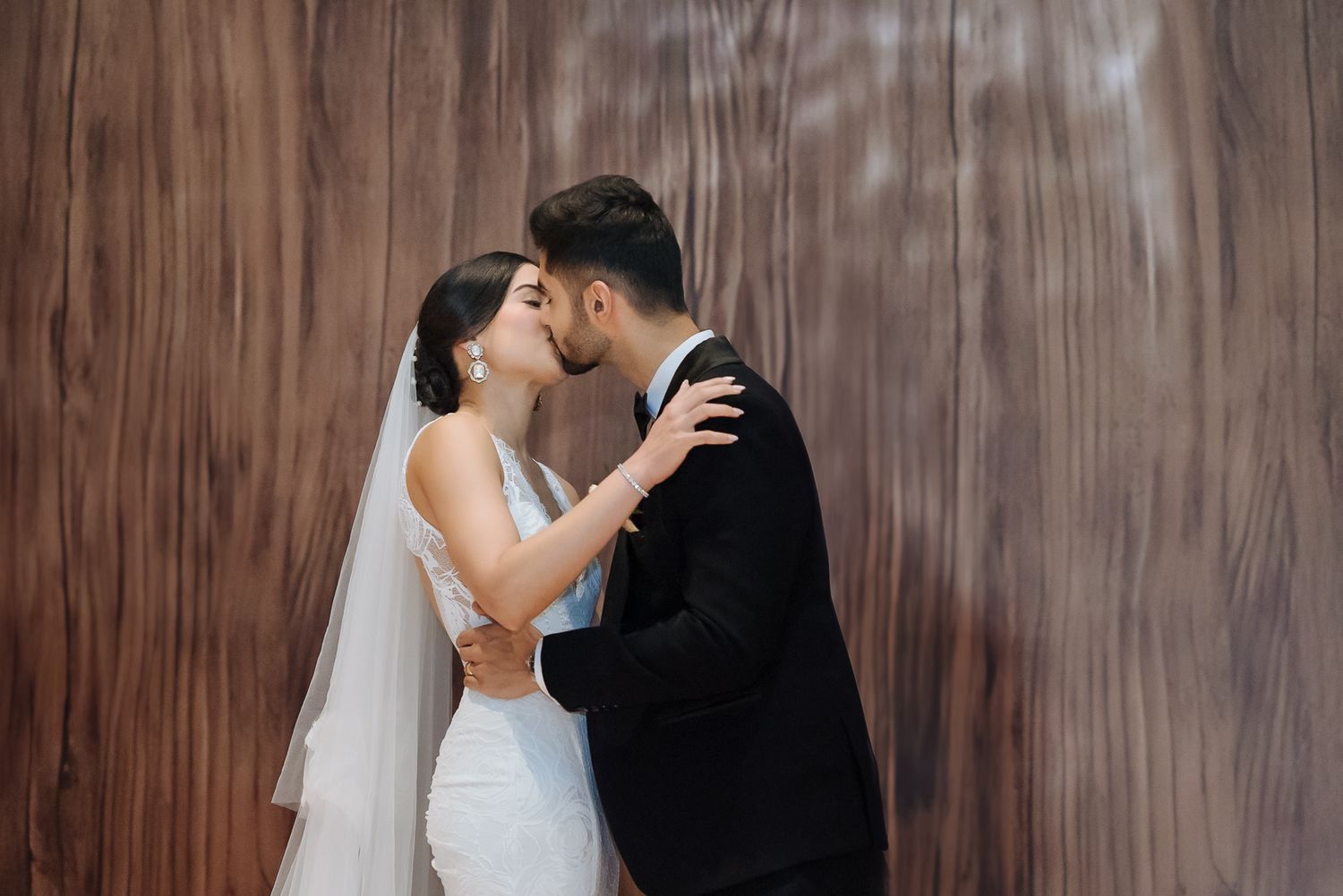 Newlyweds Shorye and Leah sharing a kiss after their Christian wedding ceremony at Tivoli Chattarpur