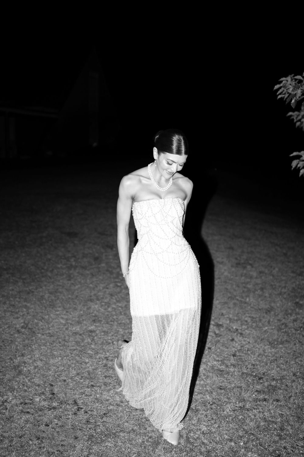 A haunting black and white photo sequence shows a figure in a white dress moving through darkness in four frames.
