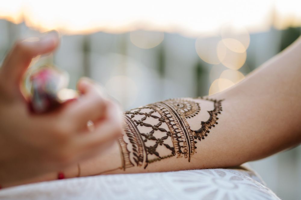 A series of hands adorned with intricate henna designs showcasing traditional mehndi patterns and details.